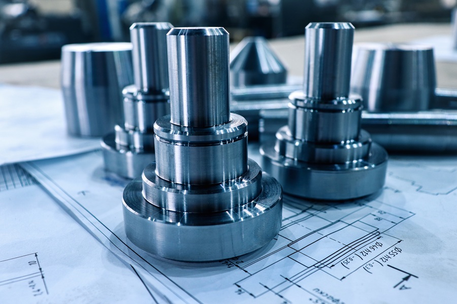 High precision CNC machined metal components on engineering blueprints